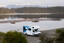 A Star RV Polaris 6 motorhome parked on a lakeshore below snow-capped Southern Alps